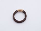 a close up of a brown braid bracelet with a gold clasp