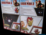 two boxes of iron man toys on a black background
