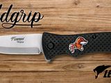 a close up of a knife on top of a wooden table