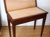 a small wooden table with a wooden top on a hard wood floor