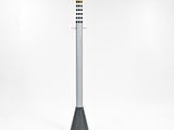 a yellow light pole with a black base and a white base