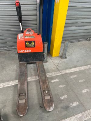 a forklift that is sitting in front of a garage door
