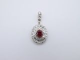a ruby and diamond pendant on a white background