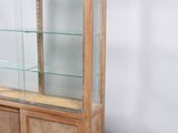 a display case with glass shelves and a wooden base