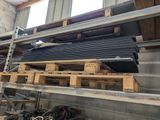 some wooden pallets are stacked on top of a shelf in a building