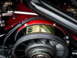 a close up of a motorcycle engine with a red cover