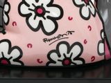 a pink purse with black and white flowers on it