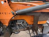 a close up of the front end of an orange tractor