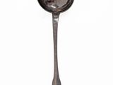 a spoon with a spoon handle on it on a white surface