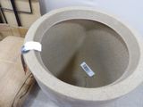 a white toilet sitting next to a beige chair
