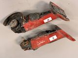 pair of old red and black fire hoses on a white surface
