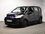 la photo d'une petite voiture noire garée dans un garage