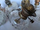 many glass lamps that are sitting on a table