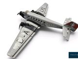a model of an airplane that is on a white surface