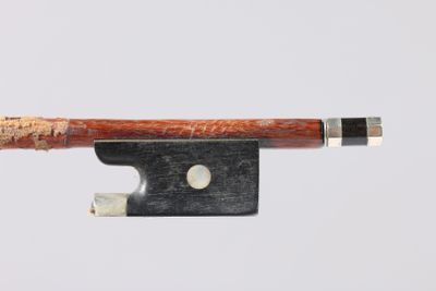 an image of a violin bow with a piece of wood sticking out of it