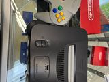 a nintendo game console sitting on top of a nintendo wii controller