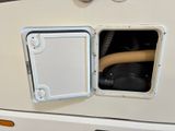 an image of a white rv with a hose in the door