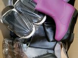 many pairs of shoes in a box on the floor