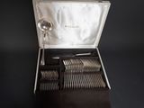 a box with silverware in it on a black surface