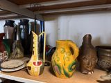 many different vases on a shelf in a room