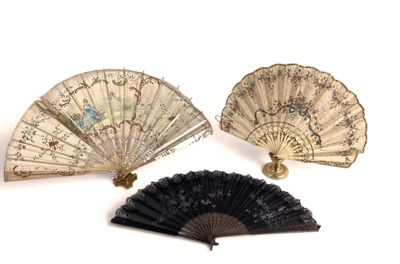 three antique fan are sitting next to each other on a white surface