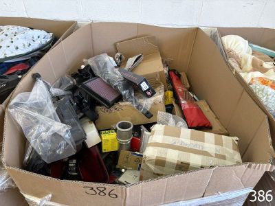 a cardboard box filled with assorted items on the floor