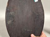 a person that is holding a black plate with a sticker on it