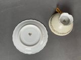 a small cup and saucer sitting on a table