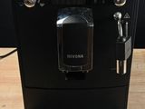 a black coffee machine sitting on a wooden table