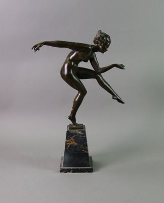 bronze statue of a woman on a marble base
