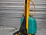 a forklift with a green and yellow fork on it
