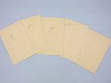 four pieces of paper with writing on them sitting on a table