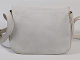the small white bag is sitting on a white surface