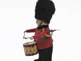 a toy soldier that is holding a drum and wearing a hat
