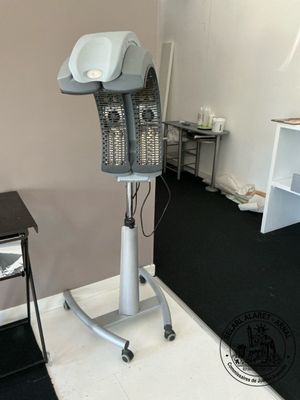 a hair dryer sitting on a stand in the corner of a room