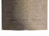 an old book with writing on it on a white surface