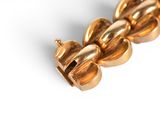 an image of a close up of a gold necklace on a white background