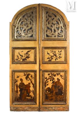 an image of a pair of wooden doors with carvings on them