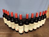 several bottles of wine are lined up on a wooden table