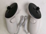 two video game controllers sitting next to each other on the floor
