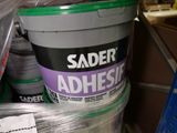 a bucket of adhesive sitting on top of a shelf