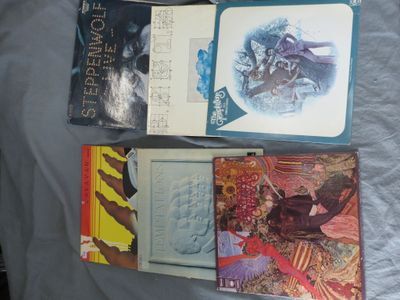 many books that are sitting on a bed together