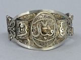 an image of a close up of a silver ring on a table
