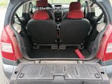 two seats in the back of a car that is open