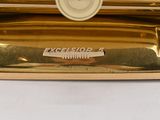 a close up of a gold plate with a button on it