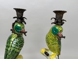 two green parrots sitting on top of each other