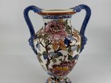 an image of a vase with flowers and birds on it