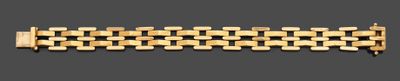 an image of a close up of a gold bracelet on a gray background