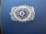 a blue box with a white lace design on it