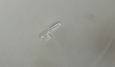 a close up of a metal object on a white surface